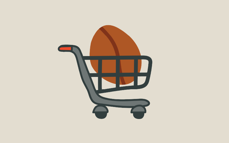 A cartoon image of a huge coffee bean inside a shopping trolley.