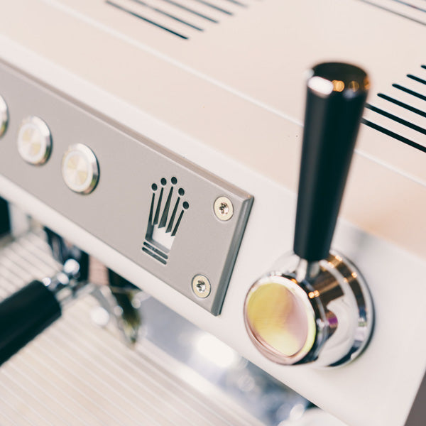A close up view of the conti ace espresso machine and the conti logo