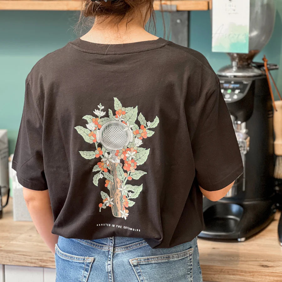 The back of a black tshirt with a floral portafilter drawn on the back
